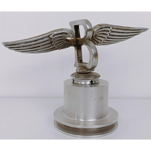 457 - A Bentley Winged B mascot, repaired, 23 cm wingspan, on a modern stand