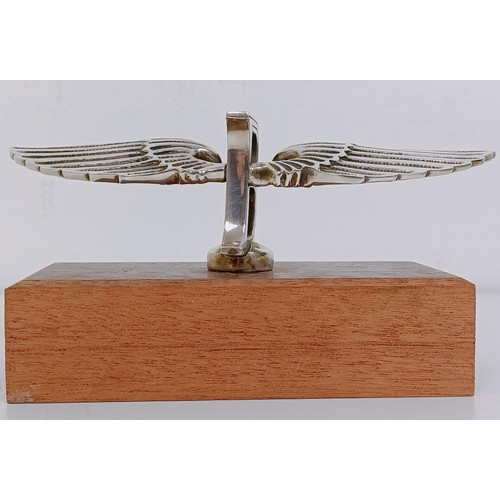 459 - A small Bentley Winged B mascot, wingspan 17 cm, mounted on a wooden block