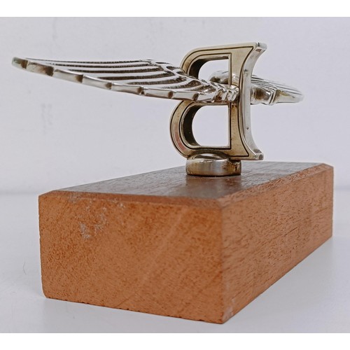 459 - A small Bentley Winged B mascot, wingspan 17 cm, mounted on a wooden block