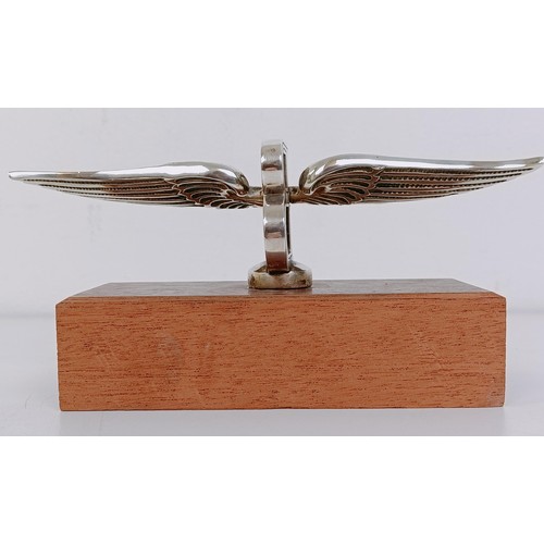 459 - A small Bentley Winged B mascot, wingspan 17 cm, mounted on a wooden block