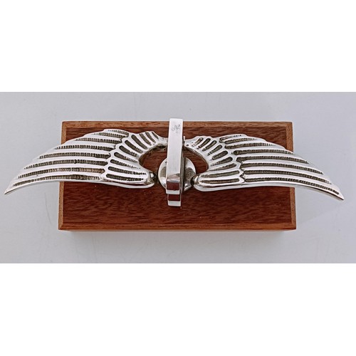 459 - A small Bentley Winged B mascot, wingspan 17 cm, mounted on a wooden block