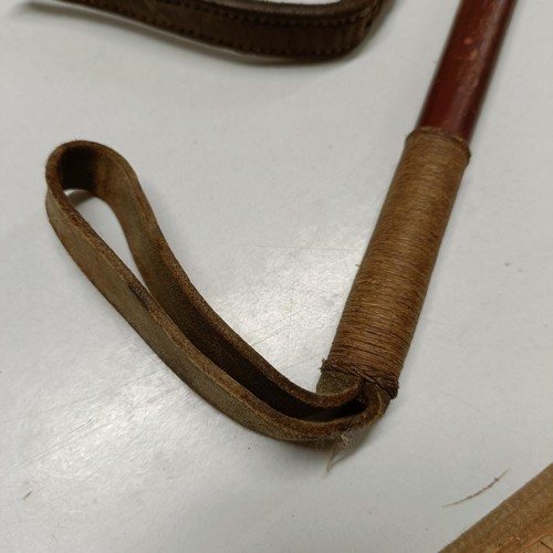 704 - A riding crop, with a silver mount, and another (2)