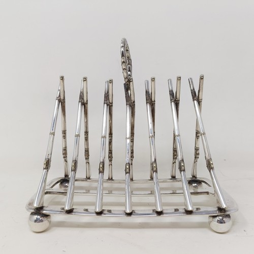 710 - A late Victorian silver plated novelty toast rack, the division in the form of shotguns, 16 cm wide