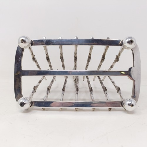 710 - A late Victorian silver plated novelty toast rack, the division in the form of shotguns, 16 cm wide