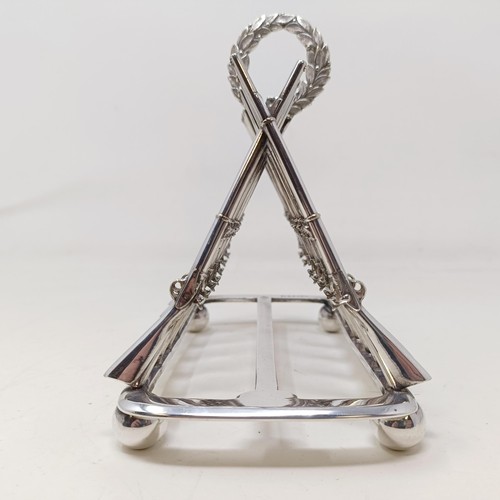 710 - A late Victorian silver plated novelty toast rack, the division in the form of shotguns, 16 cm wide