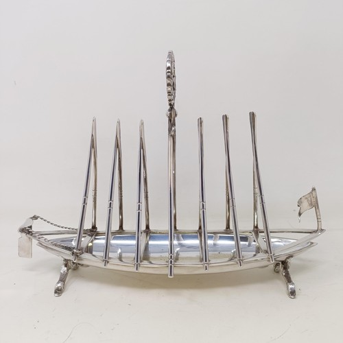 713 - A late Victorian silver plated novelty toast rack, in the form of a rowing boat, the divisions in th... 