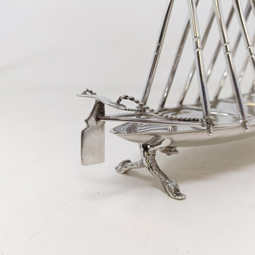 713 - A late Victorian silver plated novelty toast rack, in the form of a rowing boat, the divisions in th... 