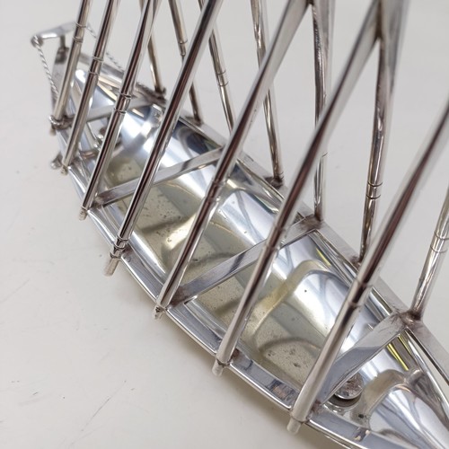 713 - A late Victorian silver plated novelty toast rack, in the form of a rowing boat, the divisions in th... 