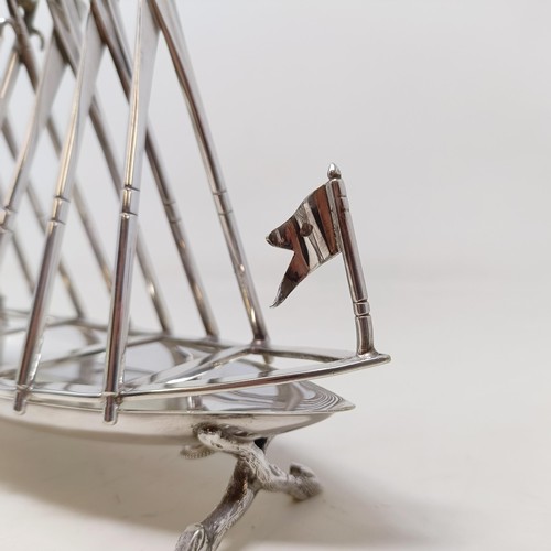 713 - A late Victorian silver plated novelty toast rack, in the form of a rowing boat, the divisions in th... 