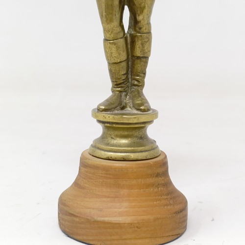 717 - A brass car mascot, in the form of a jockey, on a later wooden base, 16 cm high