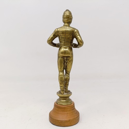 717 - A brass car mascot, in the form of a jockey, on a later wooden base, 16 cm high