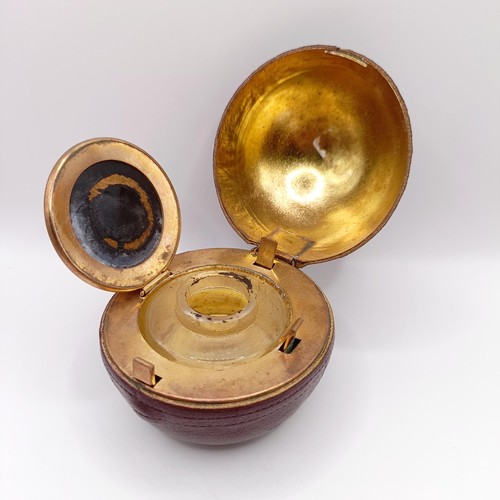 719 - A Victorian novelty inkwell, in the form of a cricket ball, 7 cm diameter