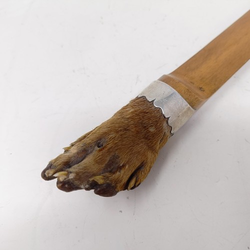 723 - A page turner, with an otter's foot handle, with a silver coloured metal mount, 38 cm