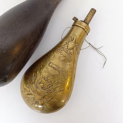 727 - A painted wooden decoy, in the form of a pigeon and a brass powder flask (2)