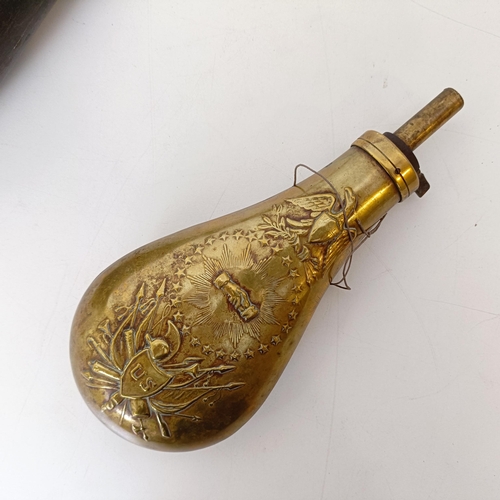 727 - A painted wooden decoy, in the form of a pigeon and a brass powder flask (2)