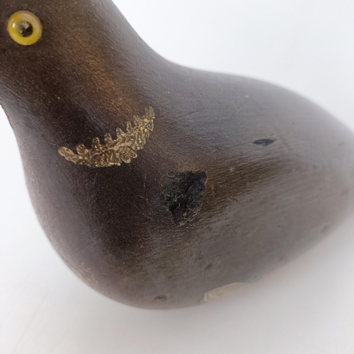 727 - A painted wooden decoy, in the form of a pigeon and a brass powder flask (2)