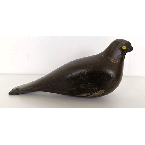 727 - A painted wooden decoy, in the form of a pigeon and a brass powder flask (2)