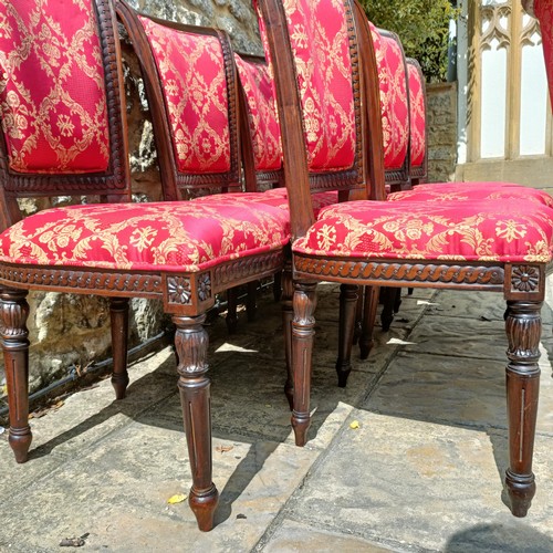 988 - A set of eight mahogany framed dining chairs with padded backs and seats