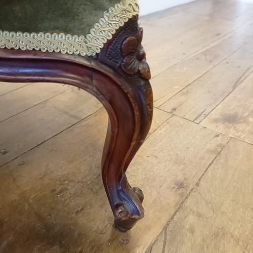 989 - A 19th century walnut framed nursing chair, with a carved pierced back