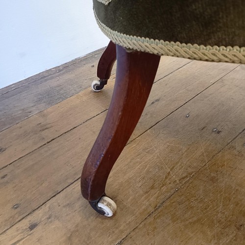 989 - A 19th century walnut framed nursing chair, with a carved pierced back