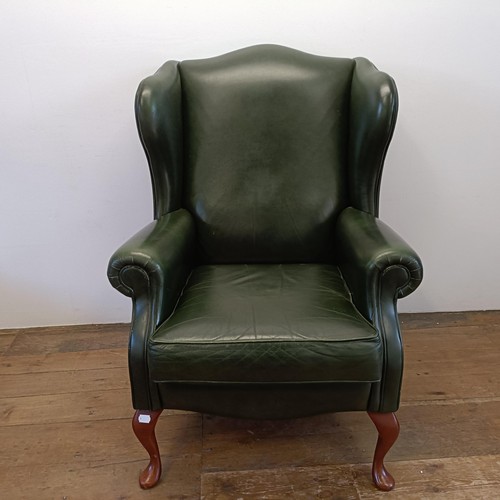 985 - A green leather wingback armchair