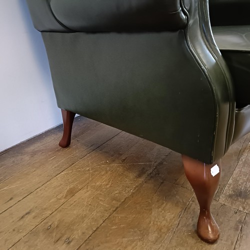 985 - A green leather wingback armchair