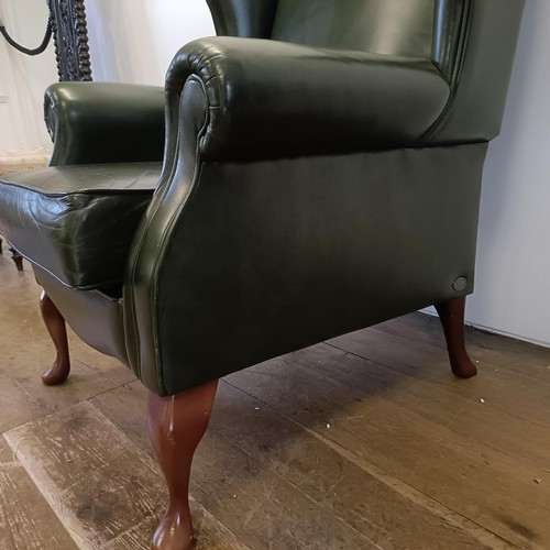 985 - A green leather wingback armchair