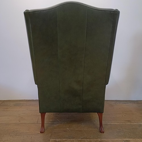 985 - A green leather wingback armchair