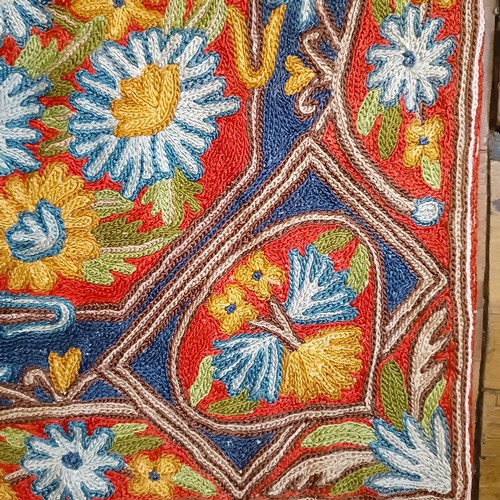 809 - A crewelwork rug, decorated flowers, 146 x 86 cm Provenance: Sold on behalf of the SNCB Society