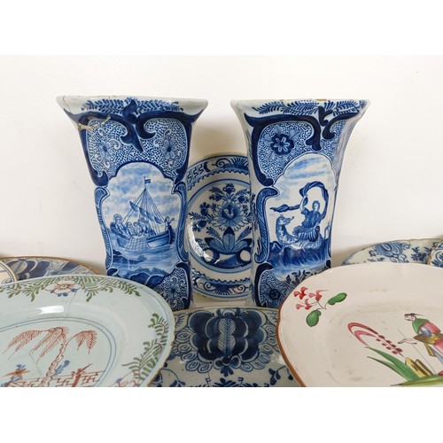 825 - A Delft blue and white plate, decorated flowers, 31 cm diameter, another similar, assorted Delft pla... 