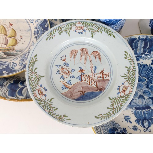 825 - A Delft blue and white plate, decorated flowers, 31 cm diameter, another similar, assorted Delft pla... 