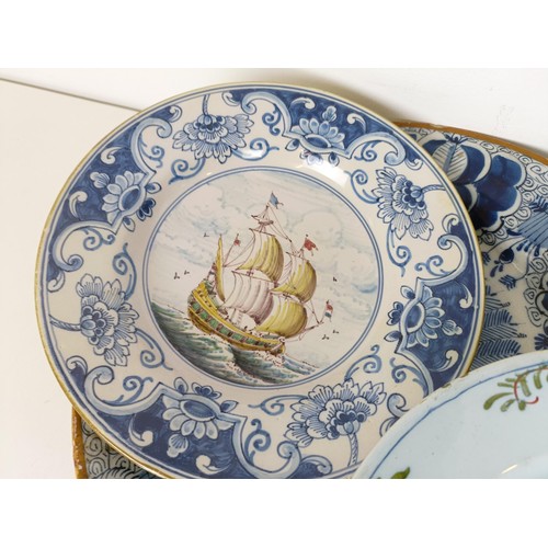 825 - A Delft blue and white plate, decorated flowers, 31 cm diameter, another similar, assorted Delft pla... 