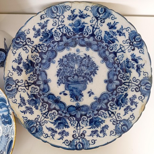 825 - A Delft blue and white plate, decorated flowers, 31 cm diameter, another similar, assorted Delft pla... 