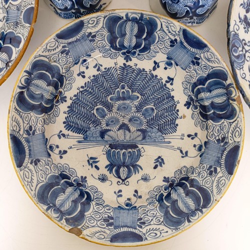 825 - A Delft blue and white plate, decorated flowers, 31 cm diameter, another similar, assorted Delft pla... 