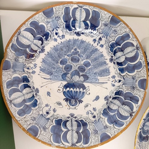 825 - A Delft blue and white plate, decorated flowers, 31 cm diameter, another similar, assorted Delft pla... 