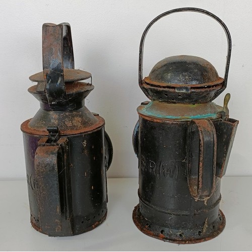 864 - A railway lamp, stamped BR(M), 29 cm high, its pair, and another lamp (3)