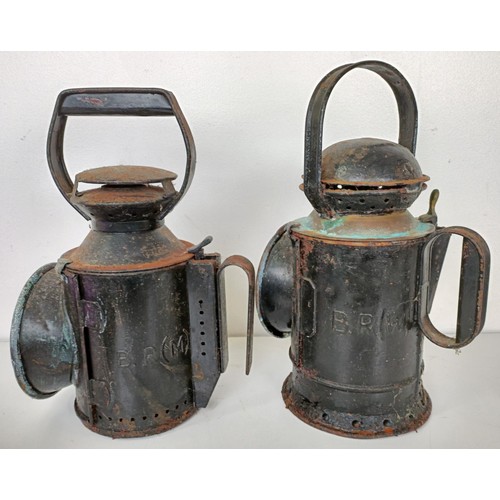 864 - A railway lamp, stamped BR(M), 29 cm high, its pair, and another lamp (3)