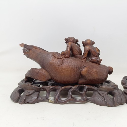 908 - A pair of Chinese carved wooden buffaloes, on stands, 21 cm wide (2)