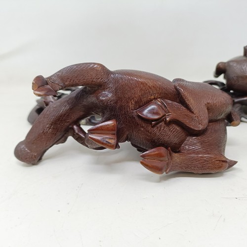 908 - A pair of Chinese carved wooden buffaloes, on stands, 21 cm wide (2)