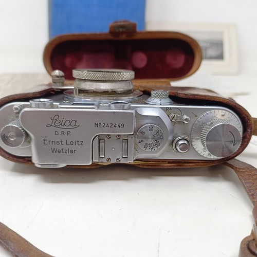 906 - A Leica IIIb camera, circa 1937/38, serial number 242449, in a leather case, with manual and tables ... 