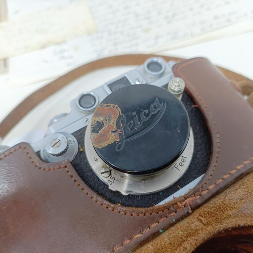 906 - A Leica IIIb camera, circa 1937/38, serial number 242449, in a leather case, with manual and tables ... 