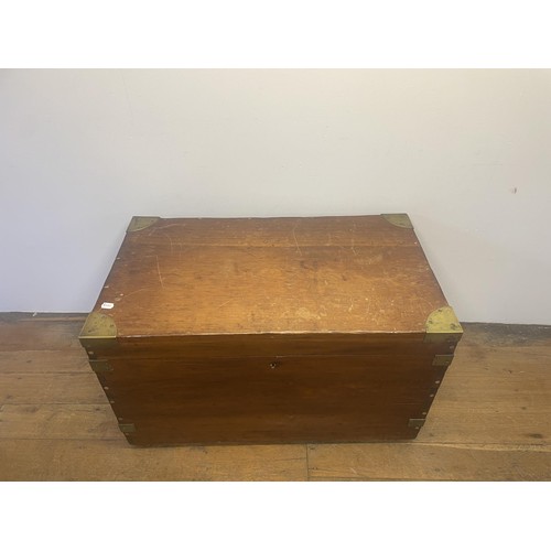 966 - A late 19th/early 20th century teak and brass bound trunk, with wrought iron handles, 100 cm wide