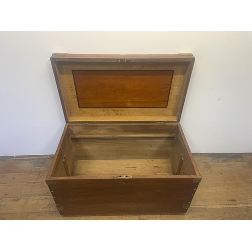 966 - A late 19th/early 20th century teak and brass bound trunk, with wrought iron handles, 100 cm wide