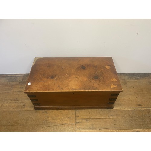 966 - A late 19th/early 20th century teak and brass bound trunk, with wrought iron handles, 100 cm wide