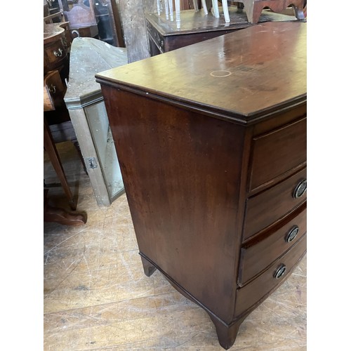 1039 - A mahogany bow front chest, having four drawers, 90 cm wide, and a commode (2)