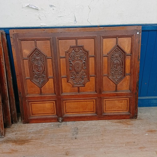 1014 - Seven mahogany walnut satinwood carved panels, reportedly from a cruise ship, carved with crest, por... 