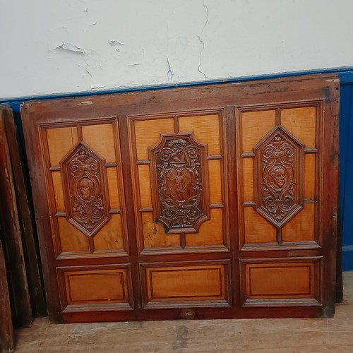 1014 - Seven mahogany walnut satinwood carved panels, reportedly from a cruise ship, carved with crest, por... 