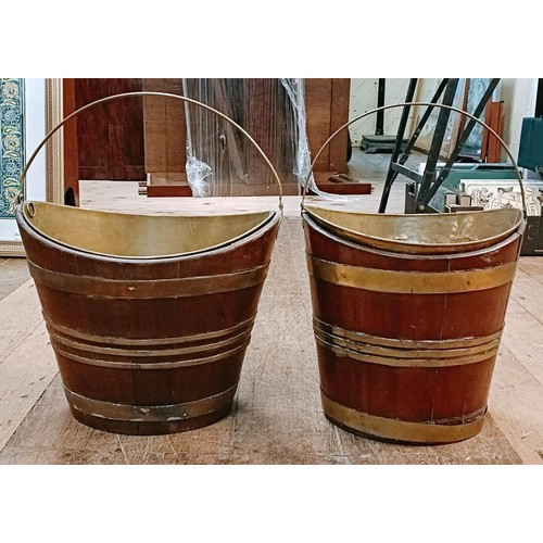 993 - A near pair of 19th century mahogany and brass bound buckets, with ring handles, 41 cm wide (2)