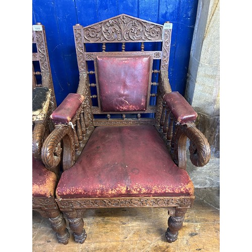 1009 - A pair of Anglo Indian carved walnut armchairs, with padded back, arms and seat, carved with foliate... 