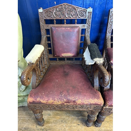 1009 - A pair of Anglo Indian carved walnut armchairs, with padded back, arms and seat, carved with foliate... 